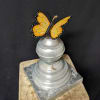 Butterfly ornament on a silver decorative pedestal