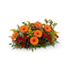 This rustic, low-profile horizontal centerpiece perfectly evokes the warmth of a crackling