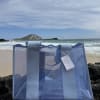 A cool, transparent blue tote with wide fabric straps and a subtle