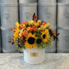 Sunflower and orange rose arrangement in a white hatbox