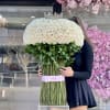 Large dome bouquet of white roses with a jeweled crown on top