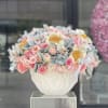 Pink and white floral arrangement in a white vase