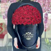 Large black hatbox filled with red roses