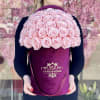 Large pink rose arrangement in a magenta hatbox