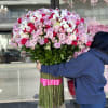 Large bouquet of pink and red roses with white orchids