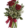 This charming bouquet includes three red roses accented with white waxflower, huckleberry