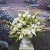 White roses, carnations, gladiolus, stock and Oriental lilies are accented with the