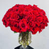 Large bouquet of red roses in a clear glass vase