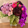 Bouquet of pink and purple flowers in a clear glass vase