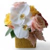 Bouquet with white orchids, pink roses, and yellow flowers in a square basket