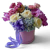 Pink and white roses with purple orchids in a lavender hatbox