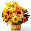 Roses sunflowers and more arranged in a modern glass cube style vase