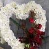 White floral heart wreath with red roses and dark orchids