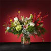 Mixed floral arrangement in a clear glass vase with red berry branches