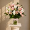 Soft pink lilies and roses take center stage in this romantic birthday