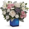 Pink and white roses with alstroemeria in a blue vase