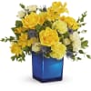 Yellow and white roses with yellow alstroemeria in a blue vase