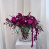 Magenta floral arrangement in a clear glass vase