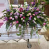 Large casket spray with pink, purple, and white flowers