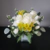 Designed in a glass cube with roses, alstroemeria, hydrangea, tulips, accent blooms