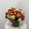 Mixed bouquet of roses, tulips, and hydrangeas in a green vase
