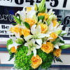 Bouquet of yellow roses and white lilies with green hydrangeas