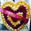 Heart-shaped rose arrangement with a pink ribbon reading "BELOVED AUNT"