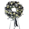A timeless expression of remembrance and respect, this striking sympathy wreath features