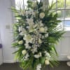 all white standing spray with roses lilies and bells of Irland