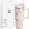 Pink heart-pattern 40 oz tumbler with handle beside branded box