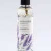 Bottle of lavender massage oil with illustrated purple lavender sprigs and a black cap