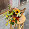 traditional Cornucopia basket with designer choice flowers and ornaments.