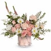 Pink roses and white daisies in a clear glass vase