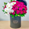 The "Burst of Love" Bouquet featuring hot pink roses and orchids is