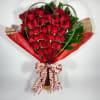 A hand-tied bouquet with a bow, leaves, and assorted greenery.  Other