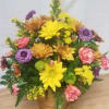 Basket arrangement of yellow, purple, pink, and orange flowers