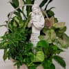 Basket of green houseplants with a white angel statue centerpiece