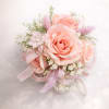 This prink roses corsage made with pink spray roses , baby's breath