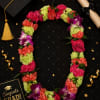 Florist handmade lei with dendrobium orchids and miniature carnations. Product shown in