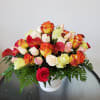 Mixed roses and calla lilies arranged in a white vase