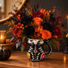 Halloween bouquet in a painted cat mug with black and orange flowers