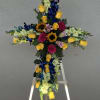 Cross-shaped floral tribute on an easel with roses and orchids