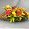 Basket arrangement with yellow roses, red carnations, and daisies