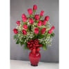 Pink roses arranged in a red vase with a red bow