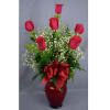 Red roses in a red vase with baby's breath and a ribbon bow