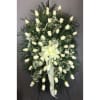White rose standing spray with baby's breath and a pale ribbon