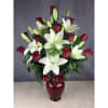 Red roses and white lilies in a burgundy vase