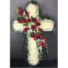 Cross-shaped floral arrangement with red roses and white flowers on an easel