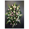Tall standing floral spray with pink and white flowers on a dark background
