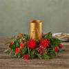 Red floral centerpiece around a gold candle holder
